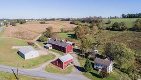 Great Land with over a half mile of road frontage and story book setting red barn