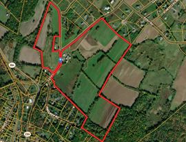 Great Land with over a half mile of road frontage and story book setting red barn